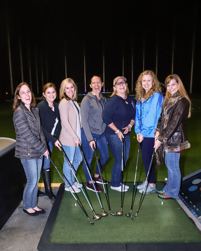 7 women holding golf clubs